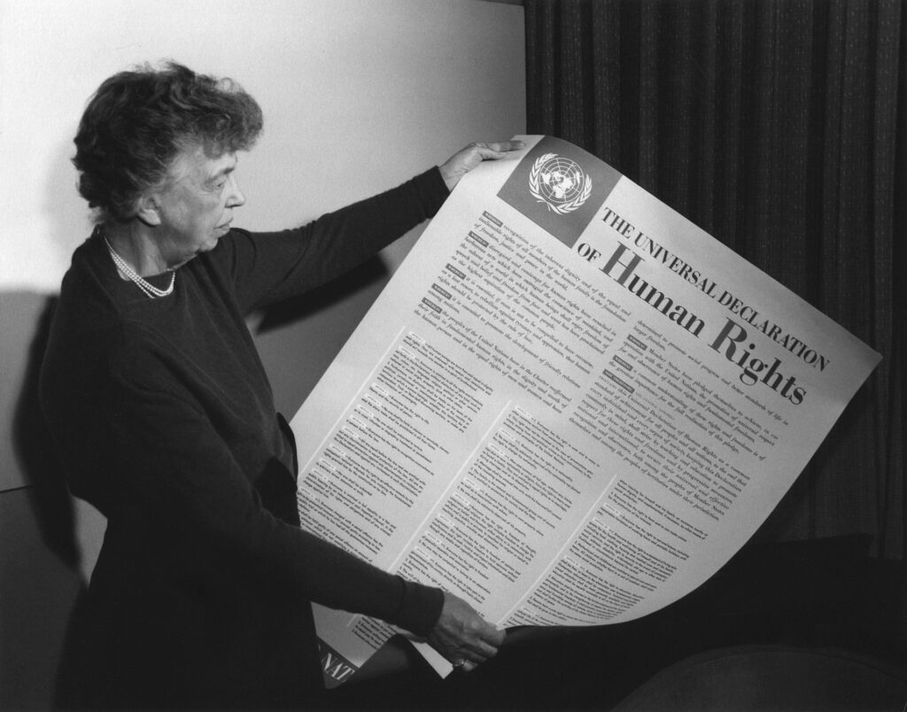 Eleanor Roosevelt holds up a copy of The Universal Declaration of Human Rights, adopted by the United Nations in December 1948